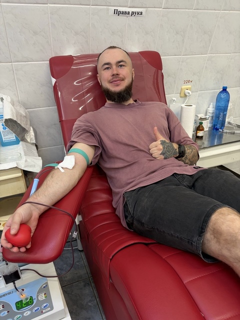 Sitting in the donation chair, giving blood for the military at the hospital